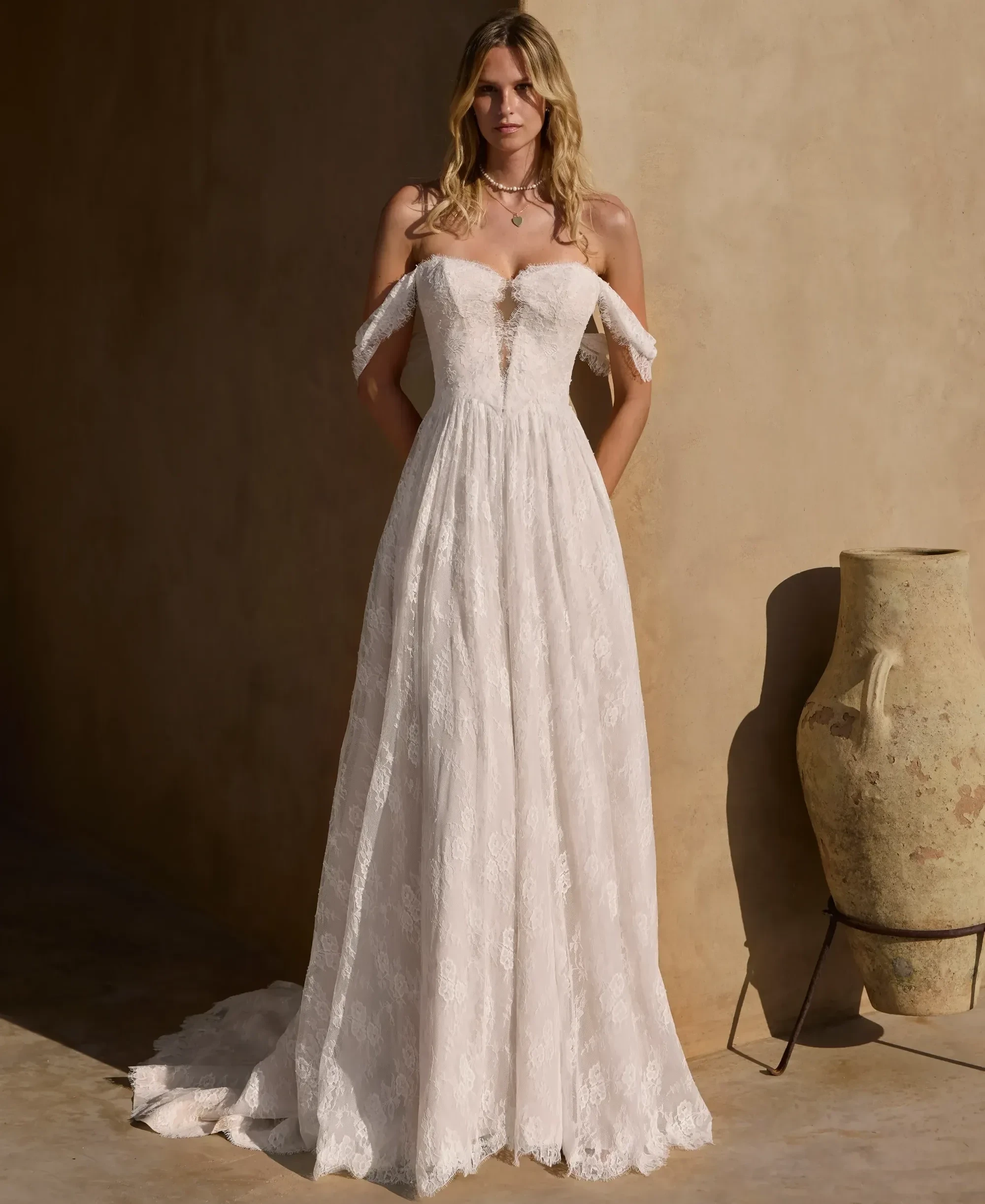 Model wearing a white gown by Lillian West