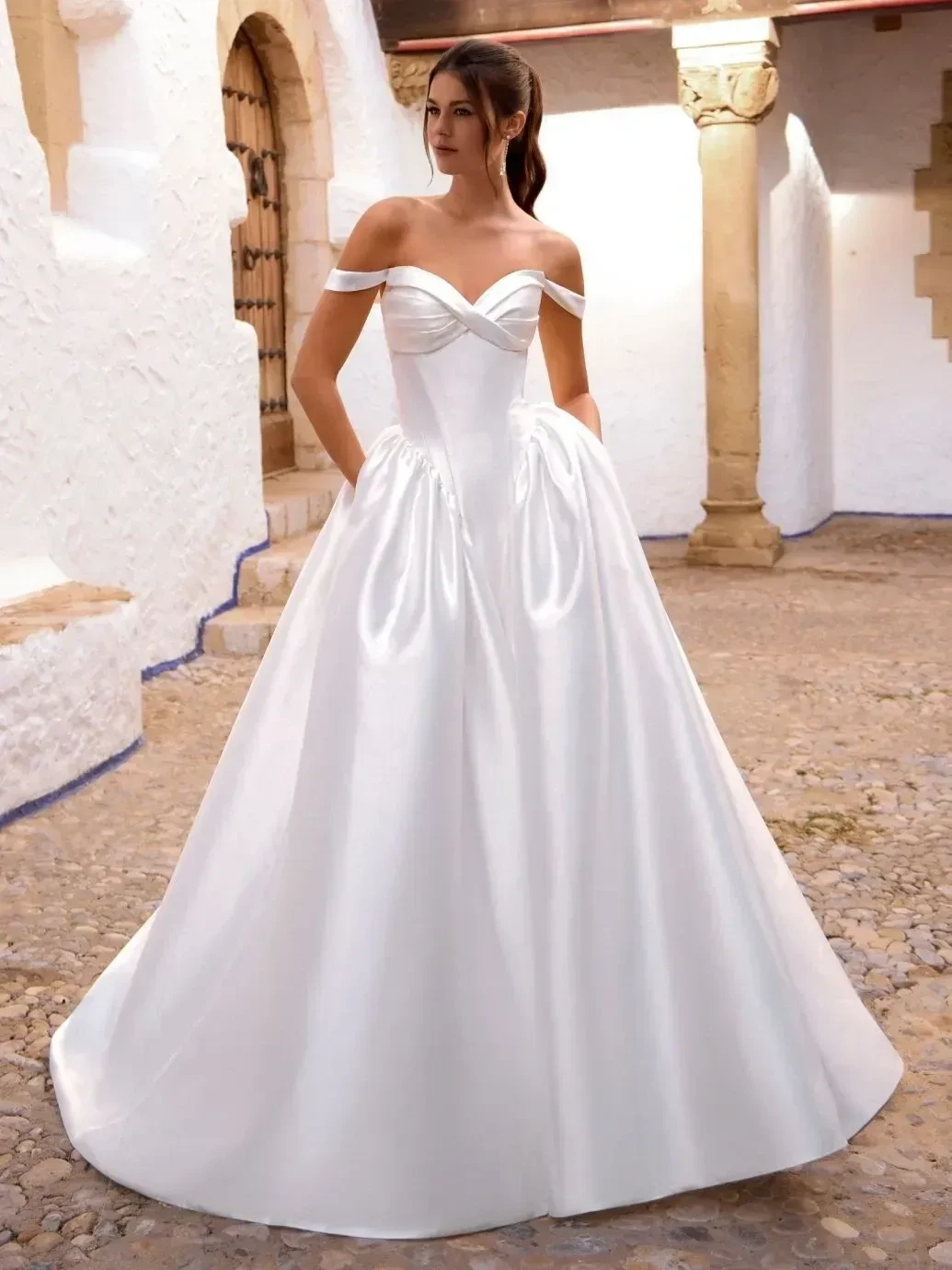 Model wearing a white gown by Enzoani Love
