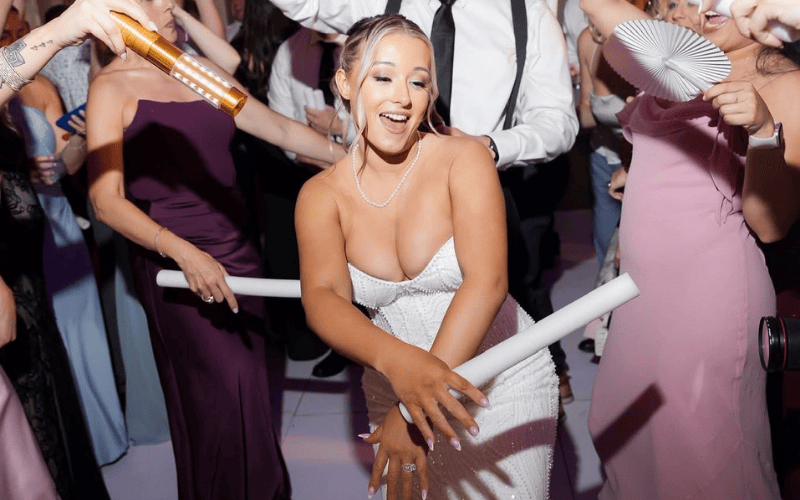 bride partying wearing a second wedding dress with playful beaded fringes 