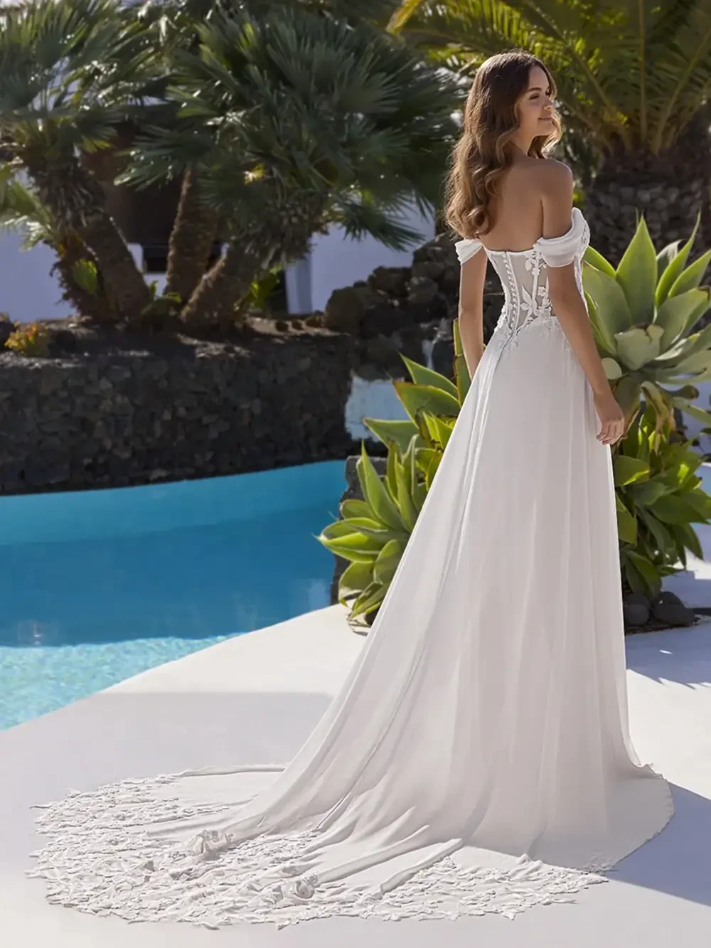 model is wearing a romantic off the shoulder a-line bridal gown