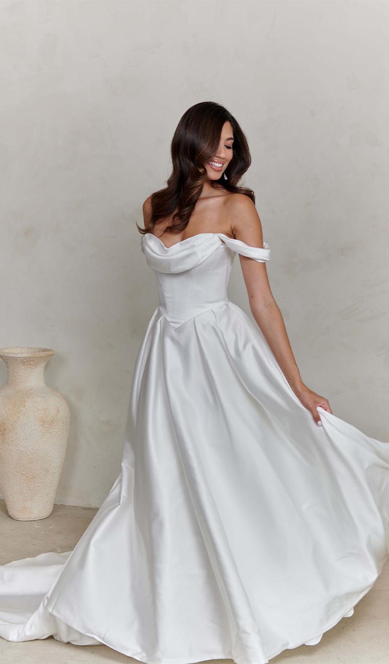 Model wearing a white gown by Madi lane