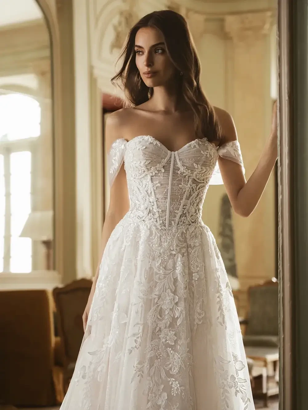 model is wearing a romantic off the shoulder bridal gown