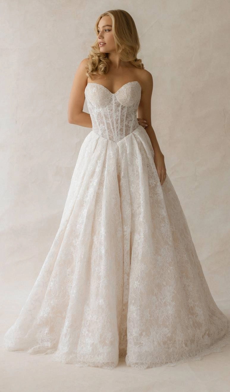 Model wearing a white gown by Abella