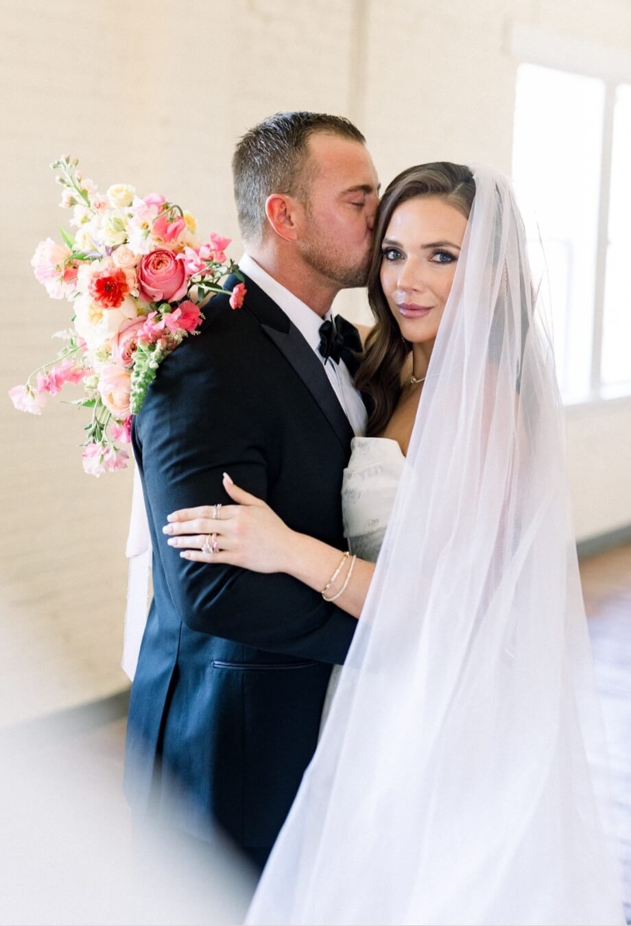 Сouple wearing a white gown and a black suit