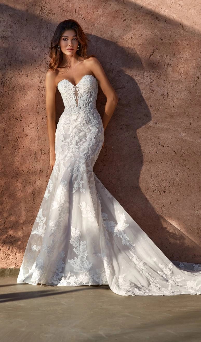 Model wearing a white gown by Madison James