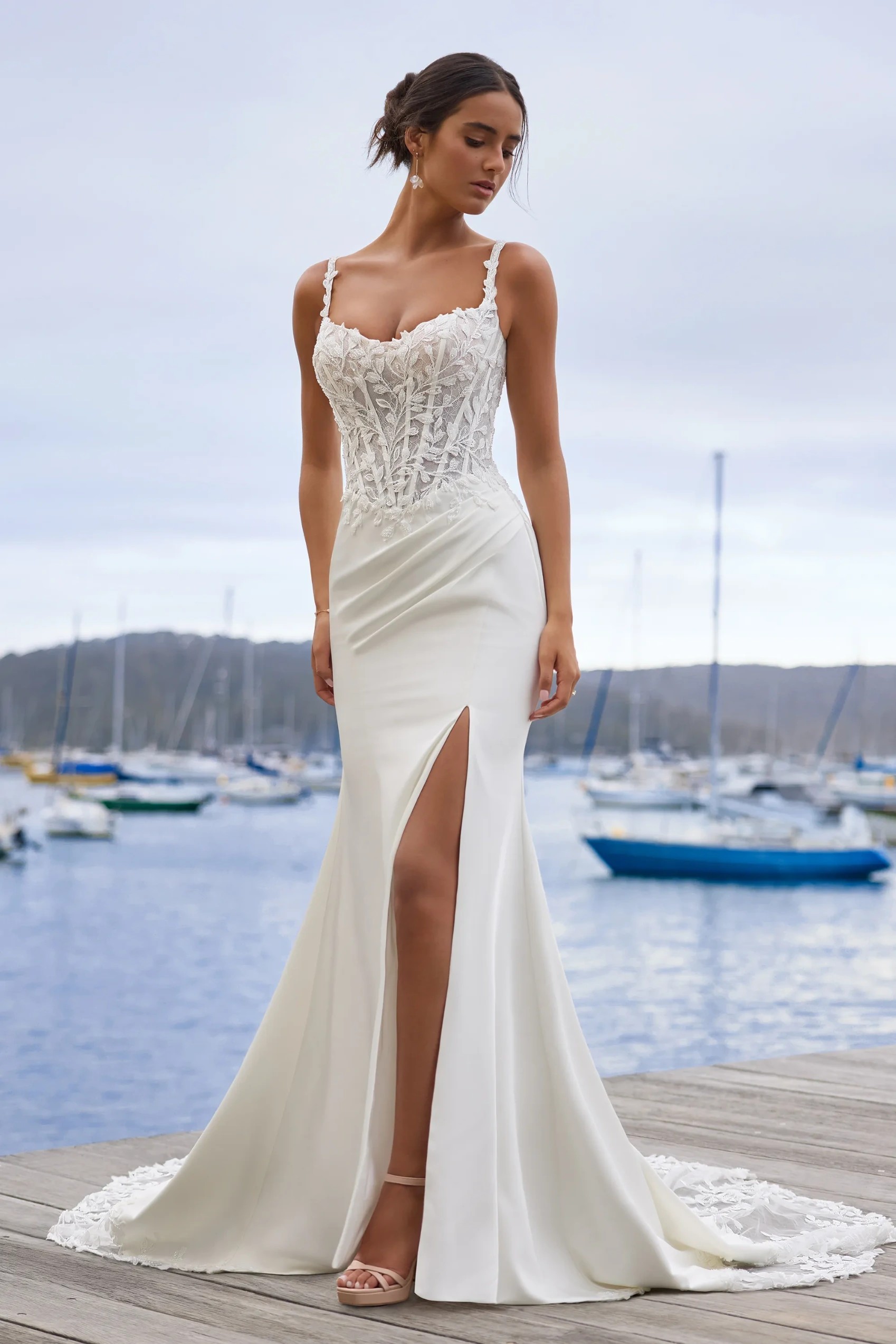 Model wearing a white gown by Sophia Tolli