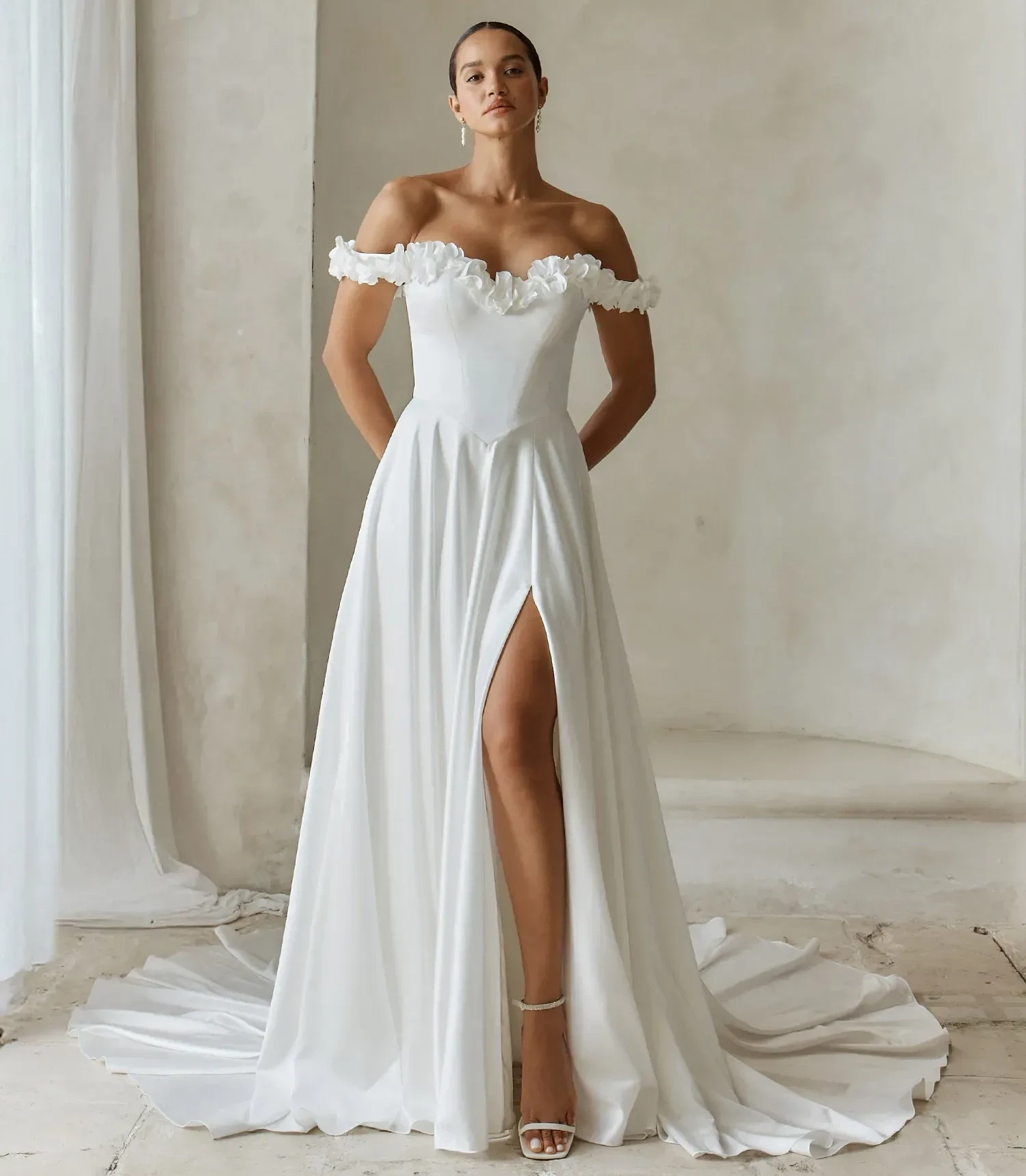 Model wearing a white gown by Madi lane