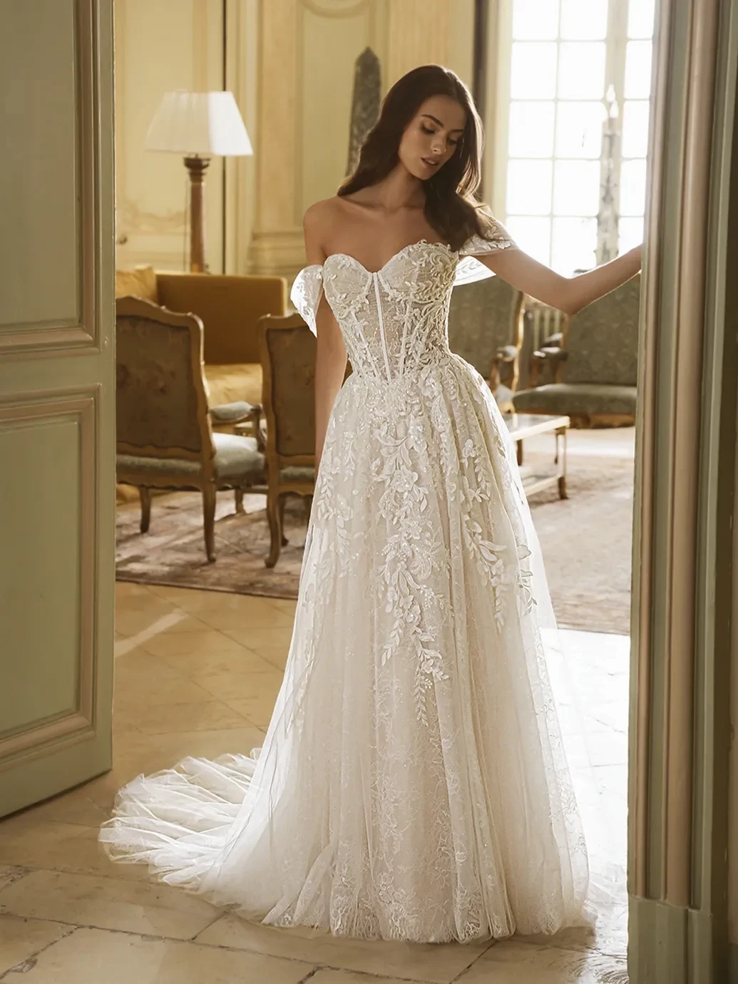 Model wearing a white gown by Elysee