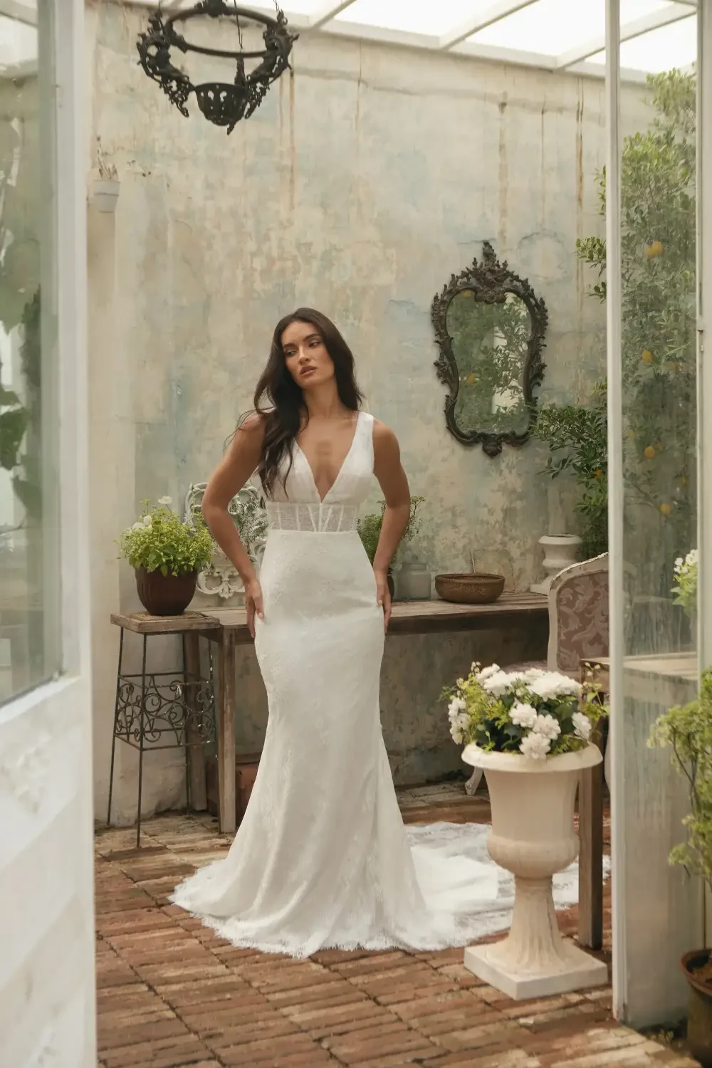 model is wearing a sleeveless a-line bridal gown